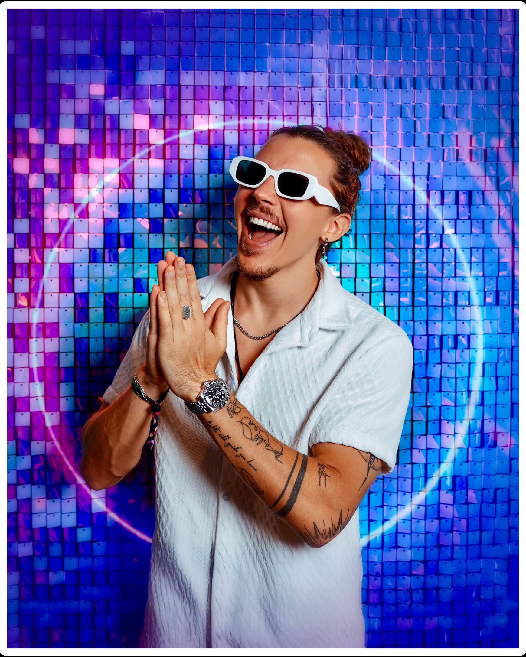 Smooth Talk wearing white sunglasses in front of a blue and purple mirrored backdrop